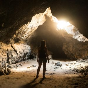 woman standing inside cave